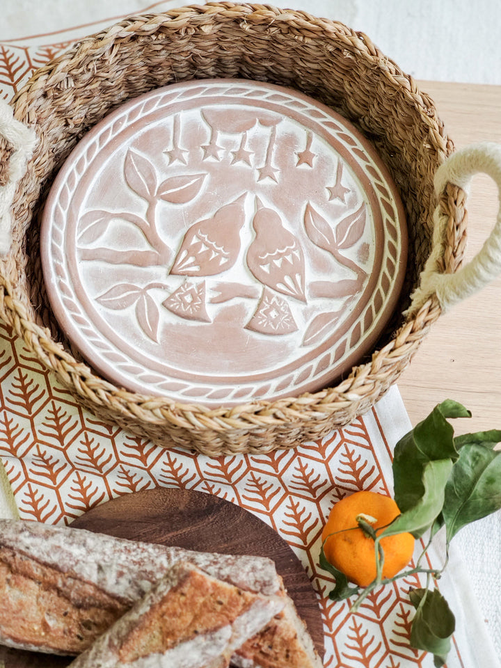 Lovebirds bread warmer basket styled on a table with bread