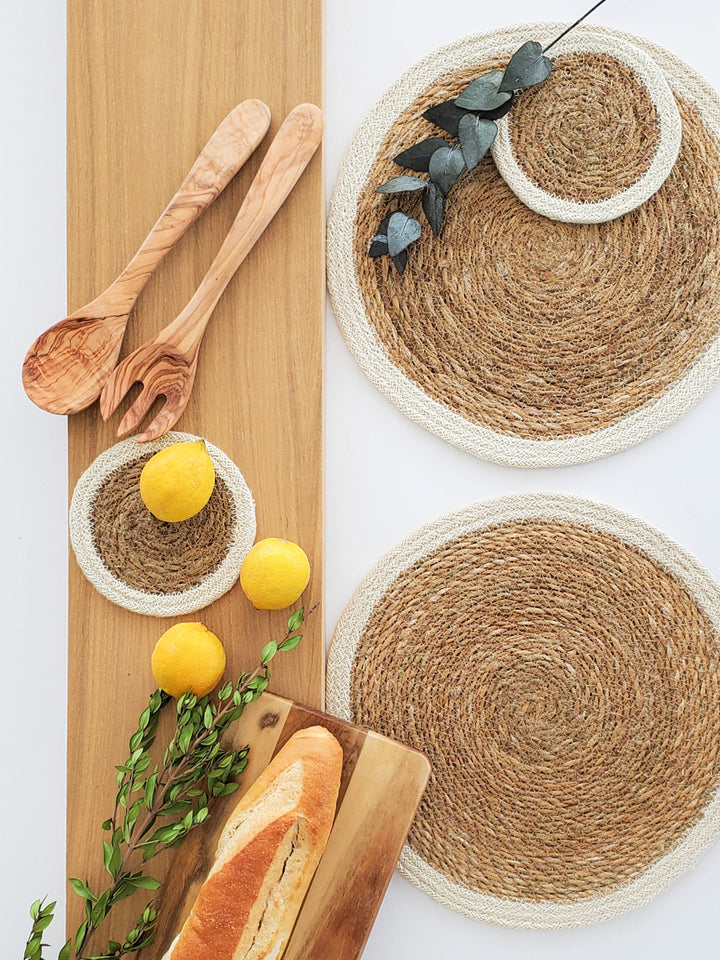 Handwoven seagrass placemat set by DC-KORISSA with natural fiber texture and earthy tones for rustic table decor.