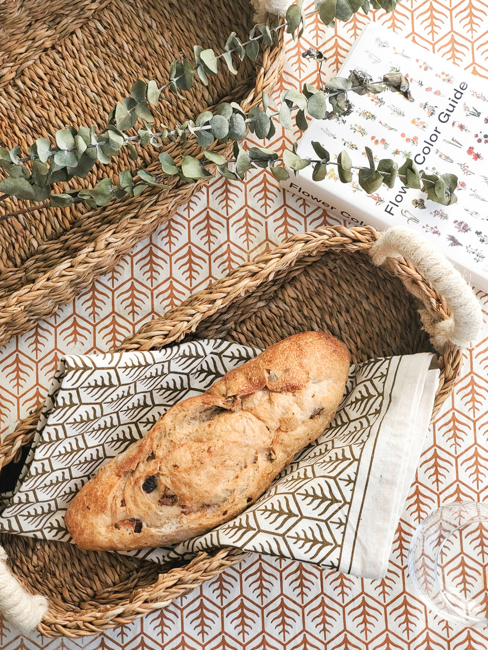 Cotton tea towels in natural color featuring screen-printed botanical tree motifs