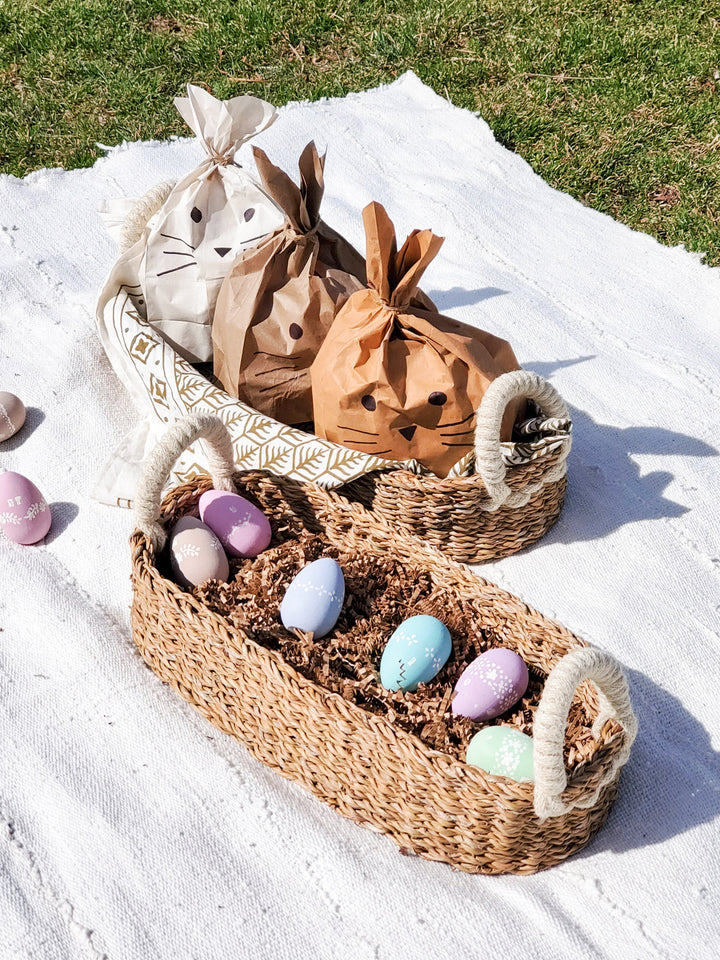 Set of two natural seagrass bread baskets with white handles, stylish and functional for serving bread.