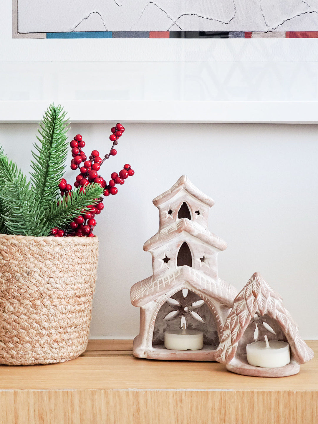 House-shaped terracotta candle lantern adding a warm glow to decor