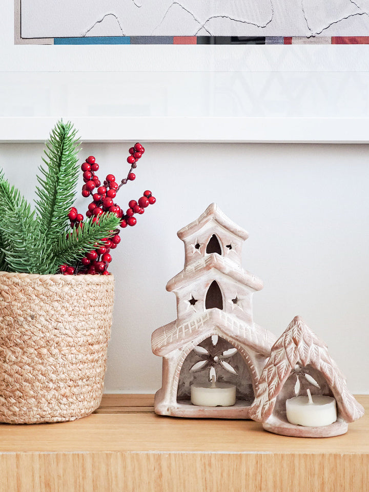 House-shaped terracotta candle lantern adding a warm glow to decor