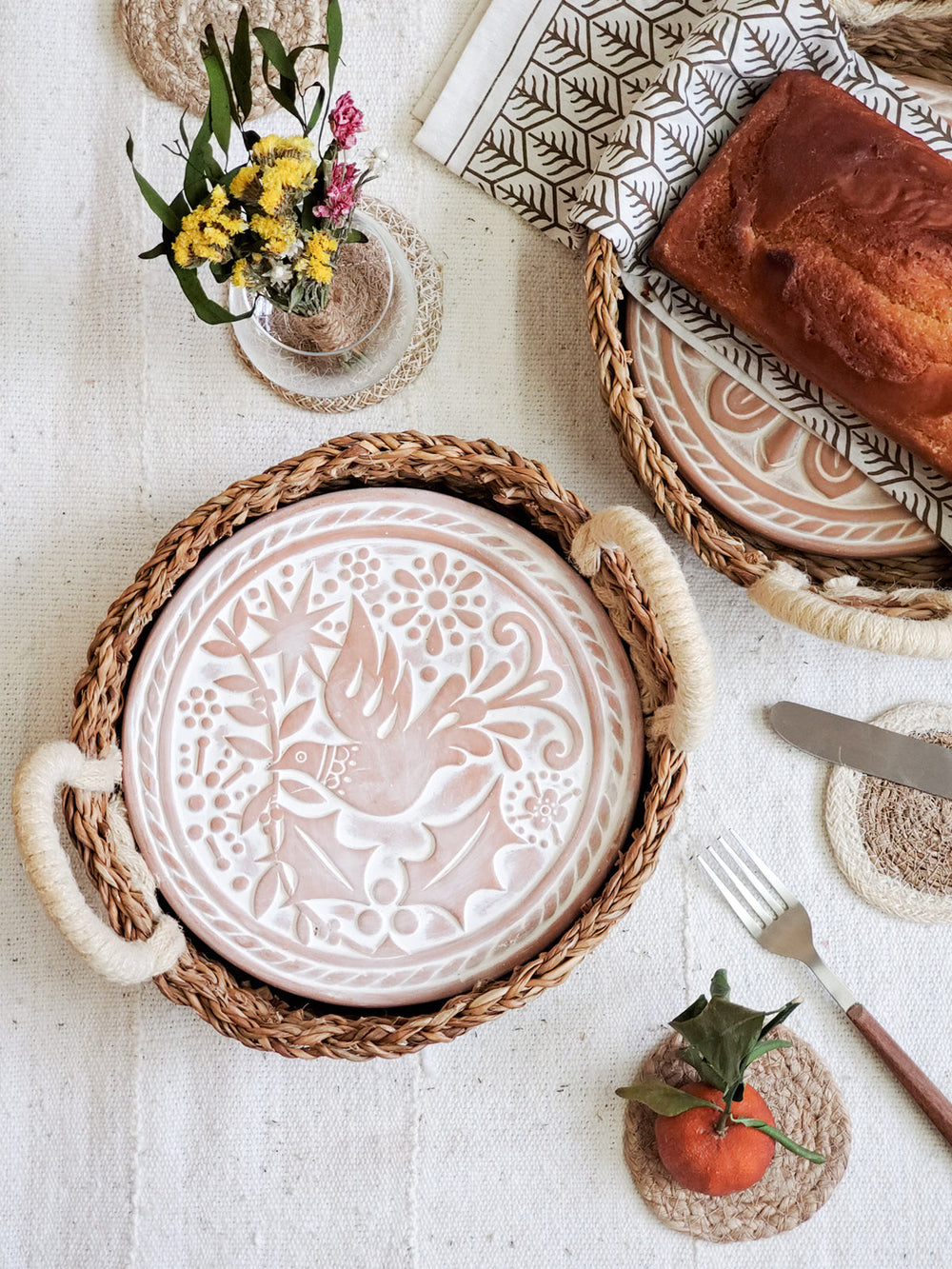 Bird-design bread warmer basket styled on a table with fresh bread