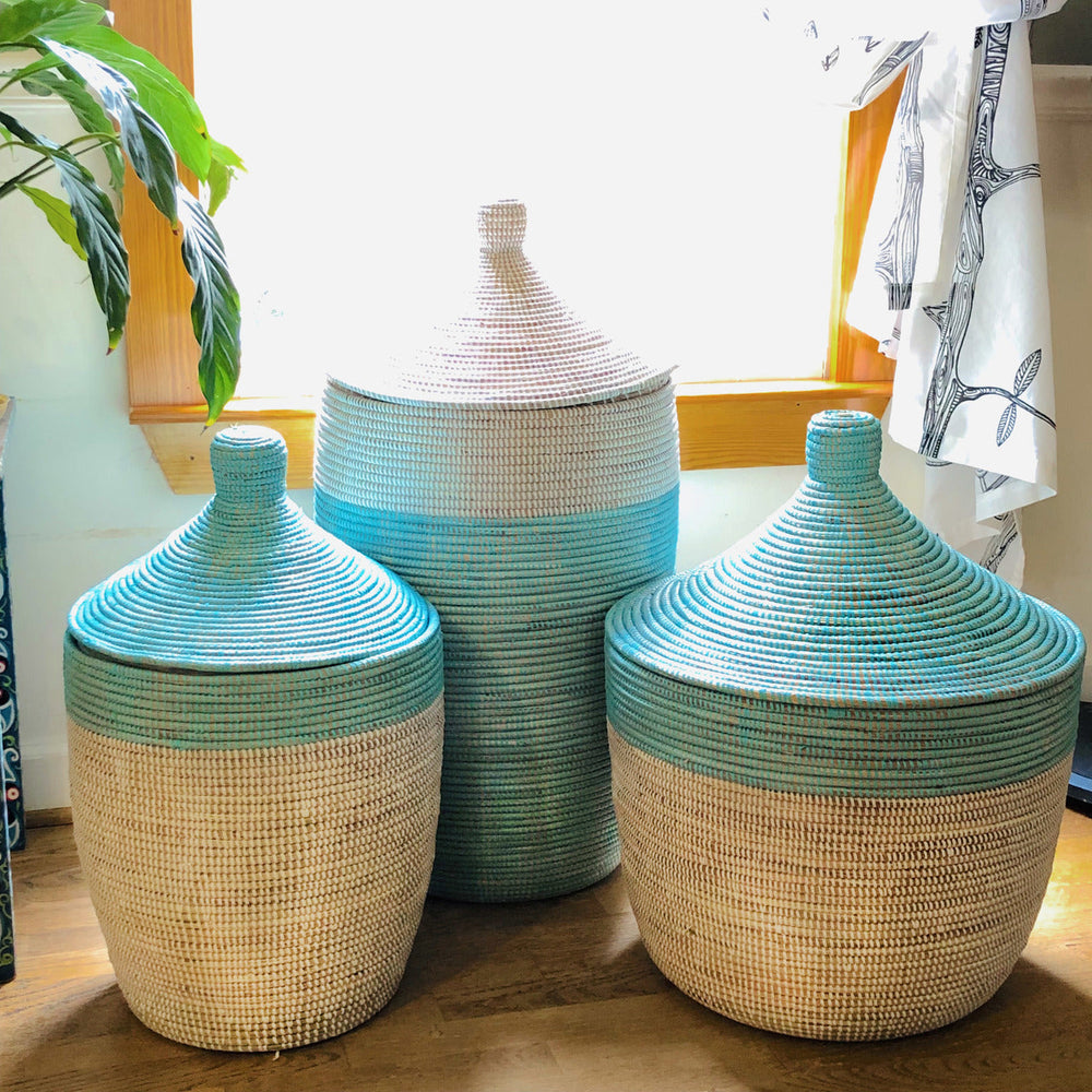 Two-tone turquoise and white storage basket, woven with sturdy handles.