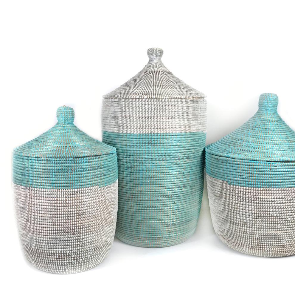 Two-tone turquoise and white woven storage basket with handles.