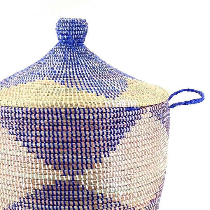Blue and natural chevron woven storage basket with a textured pattern and handles.
