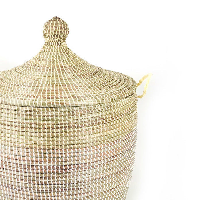 Natural and white two-tone woven basket with handles for organization.