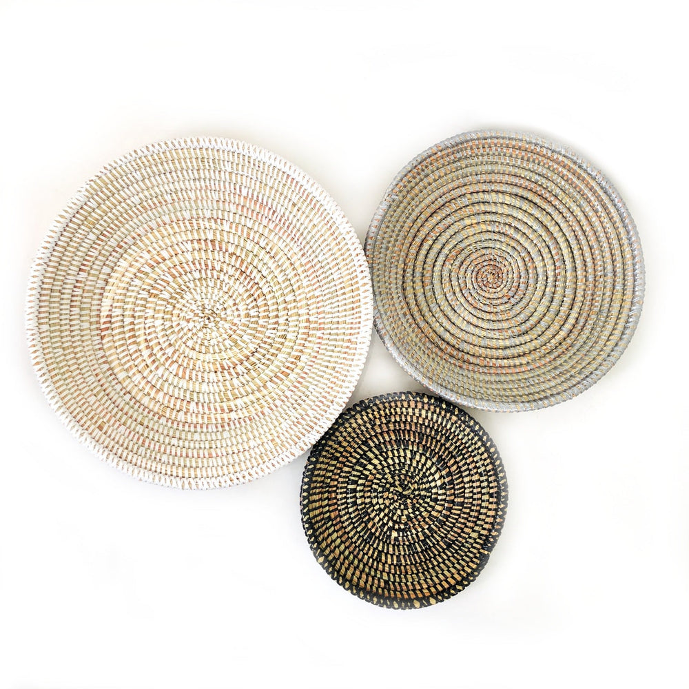 Set of three round handwoven basket bowls in neutral tones.