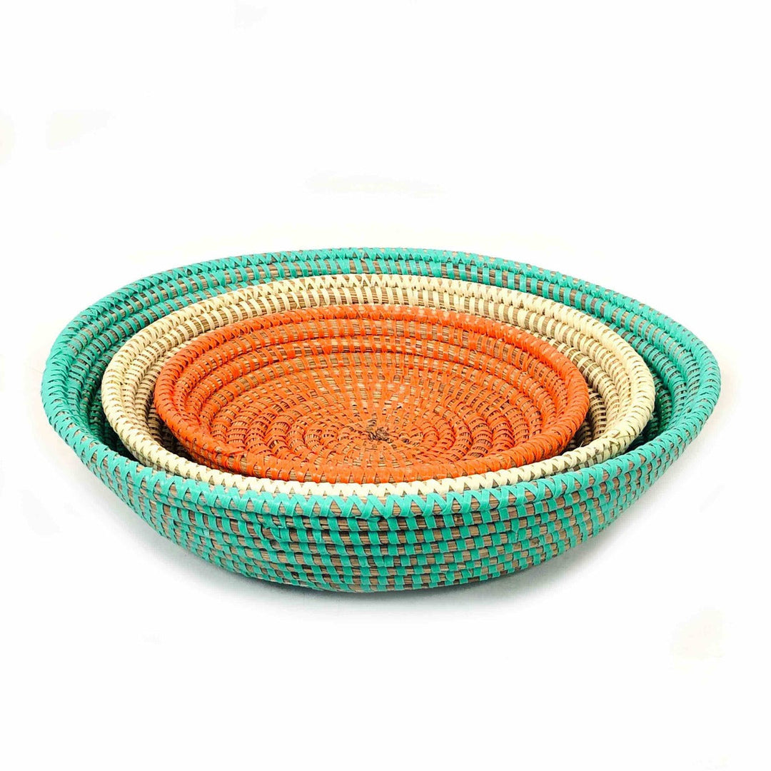 Set of three colorful handwoven basket bowls in orange, turquoise, and white.