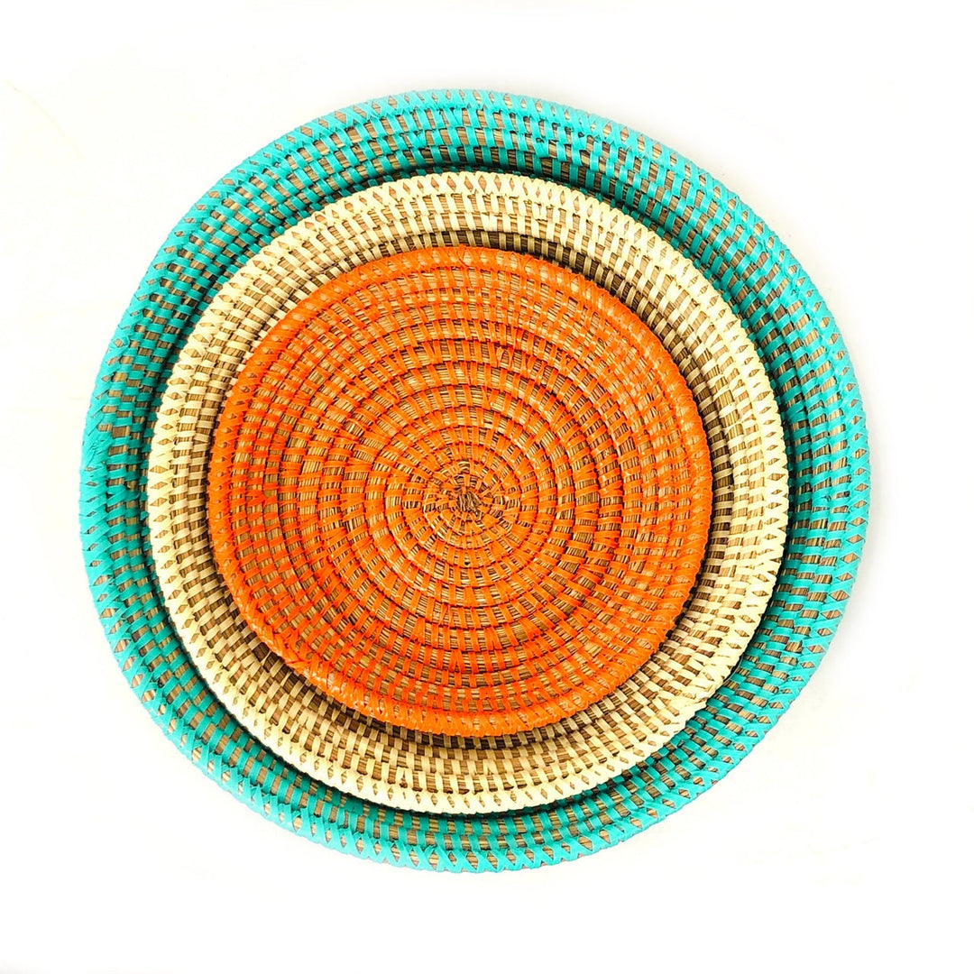 Handwoven basket bowl set in warm, vibrant tones with natural fibers.