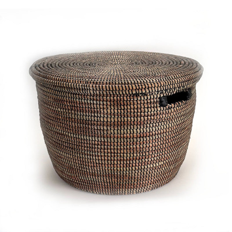 Handwoven black storage basket with flat lid, sturdy and minimalist.