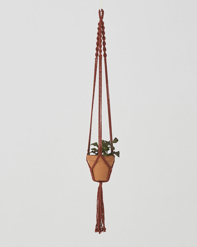 Tile-red Santana macrame plant holder with intricate knots and a hanging loop.