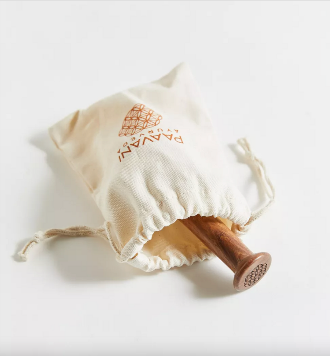 Kansa wand facial tool with a rounded end for facial massage.