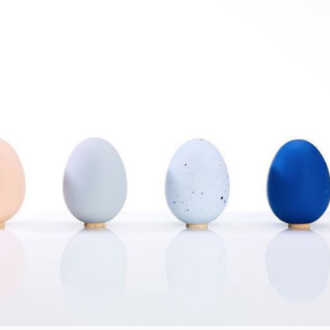 Egg-shaped porcelain salt shaker with a cork top, shown on a neutral background.