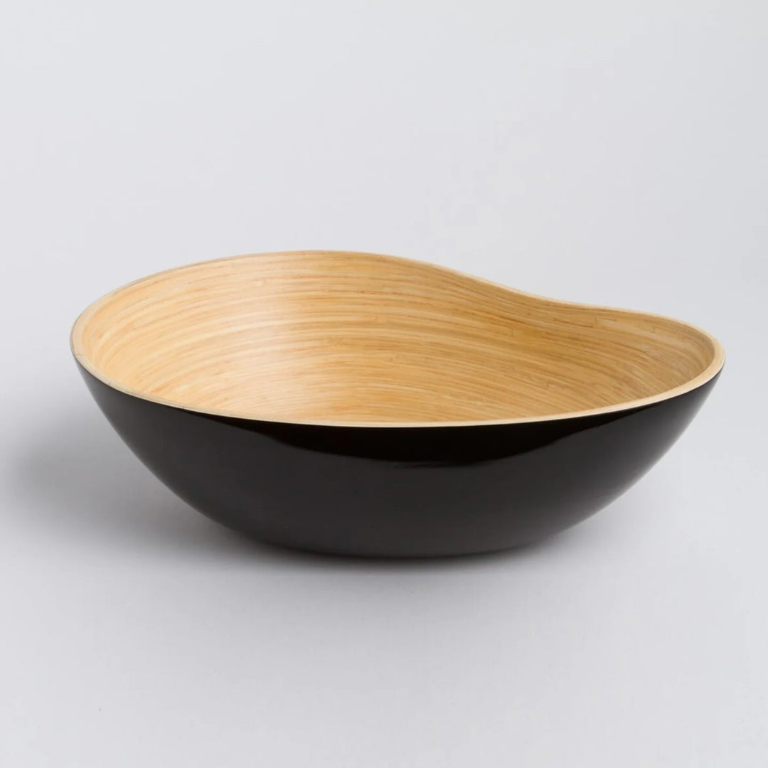Bamboo serving bowl shaped like a mango, showing the natural texture.