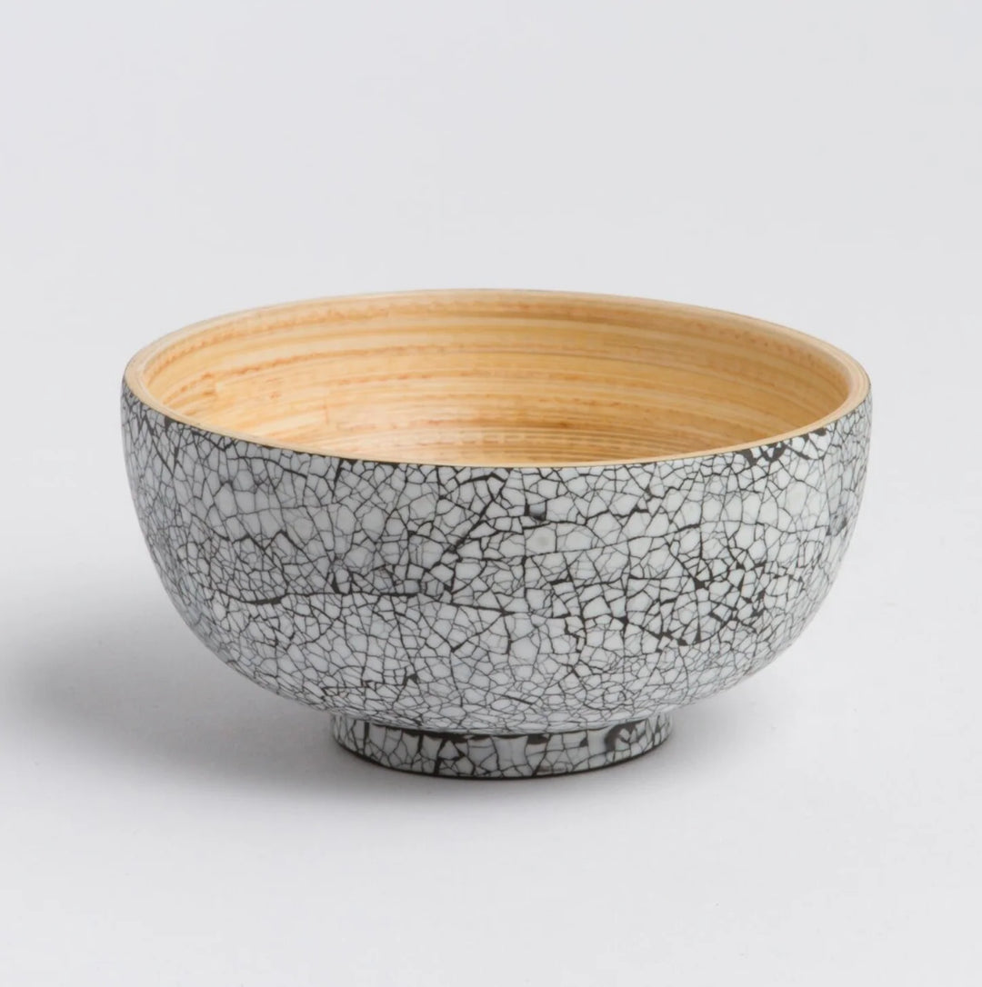 Handcrafted bamboo dining bowl with natural grain and a rounded shape.