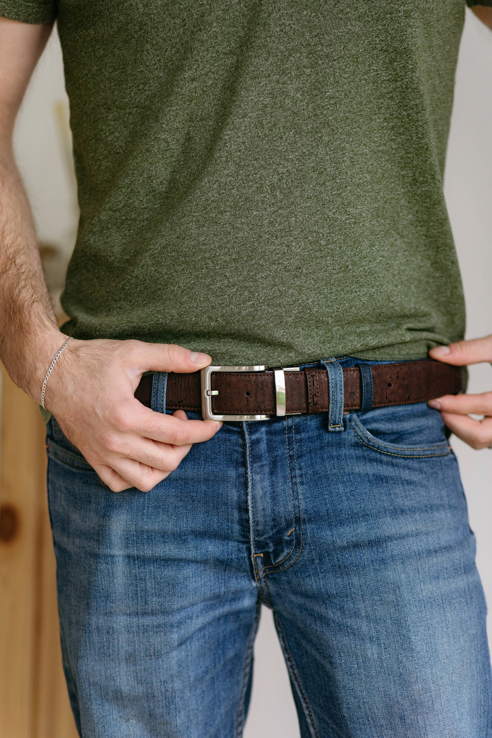 Reversible cork belt with brown and navy sides, a metal buckle, and textured cork finish.