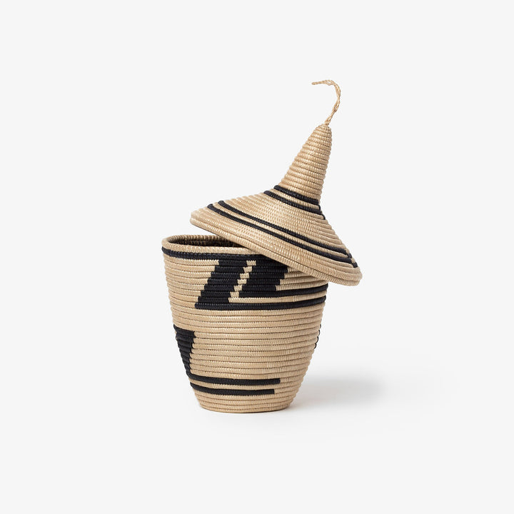 Black and tea sisal peace basket with a handle and intricate woven design.