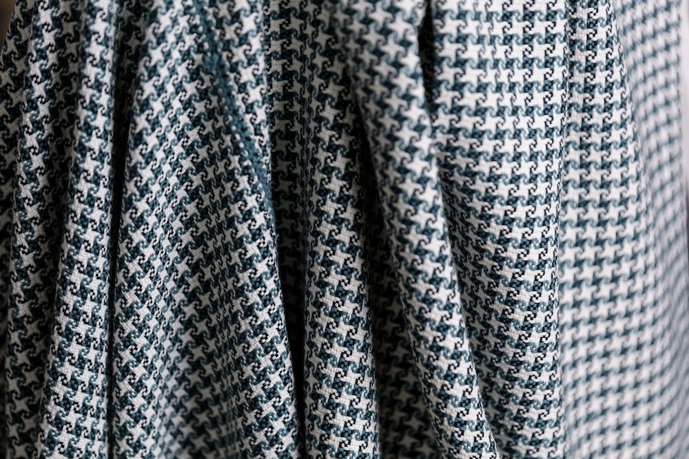 Close-up of the slate and white pinwheel check in hand-spun cotton.