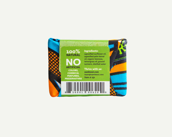 Organic lemongrass soap bar with beeswax, shown with fresh lemongrass leaves.
