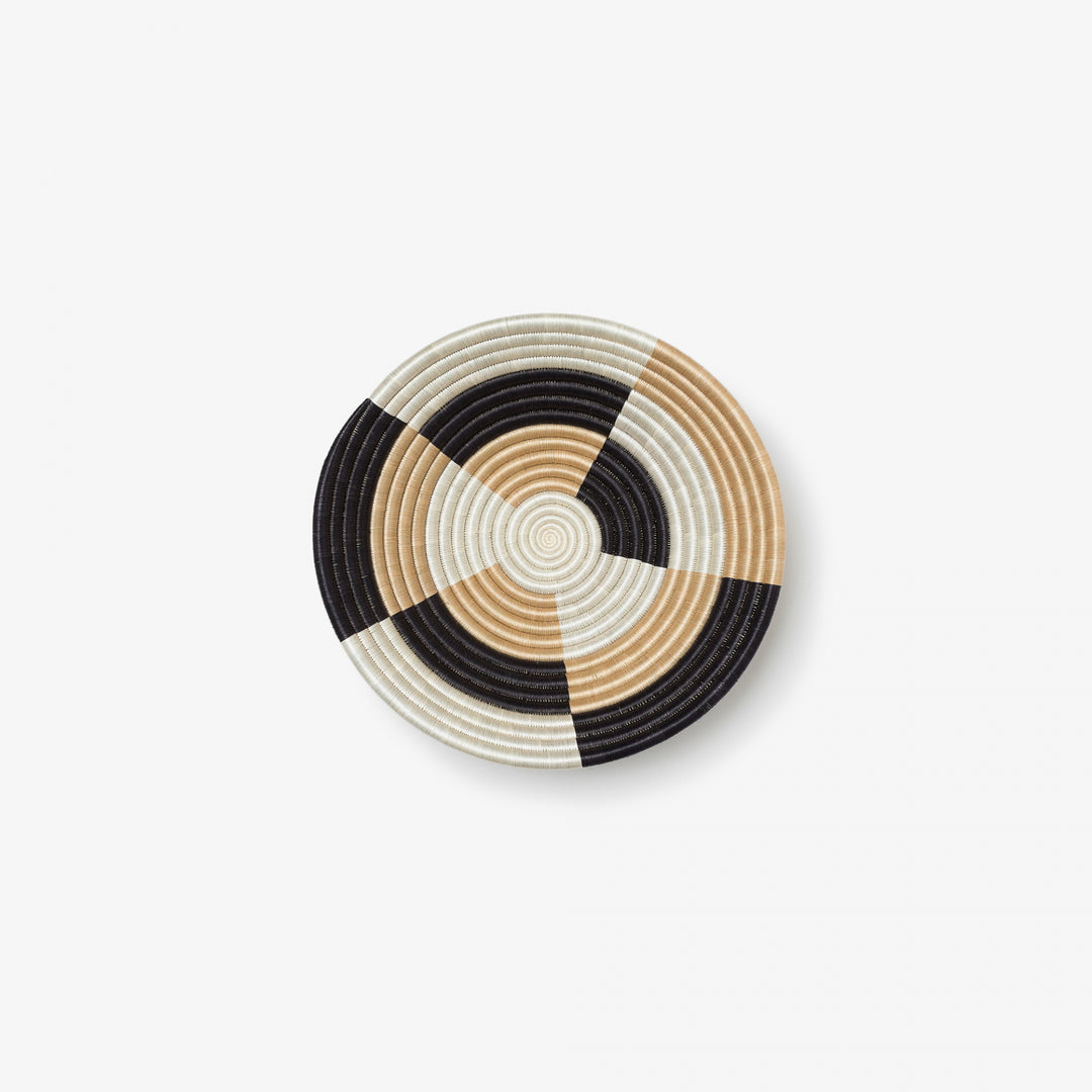 Small Staccato woven bowl with a quarter-pinwheel pattern for wall display.