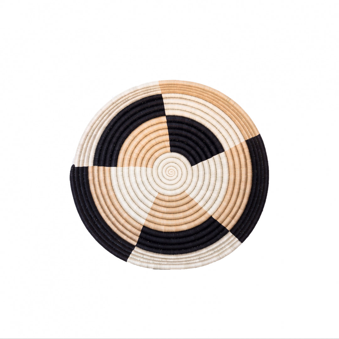 Large Staccato woven bowls arranged as wall decor in black and tea-toned sisal.
