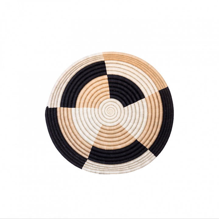 Large Staccato woven bowls arranged as wall decor in black and tea-toned sisal.