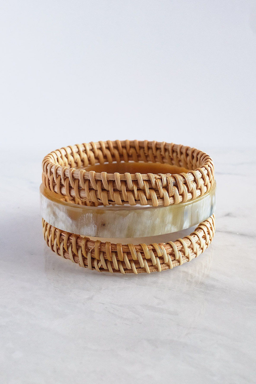 Handwoven set of cream buffalo horn and rattan bangles.