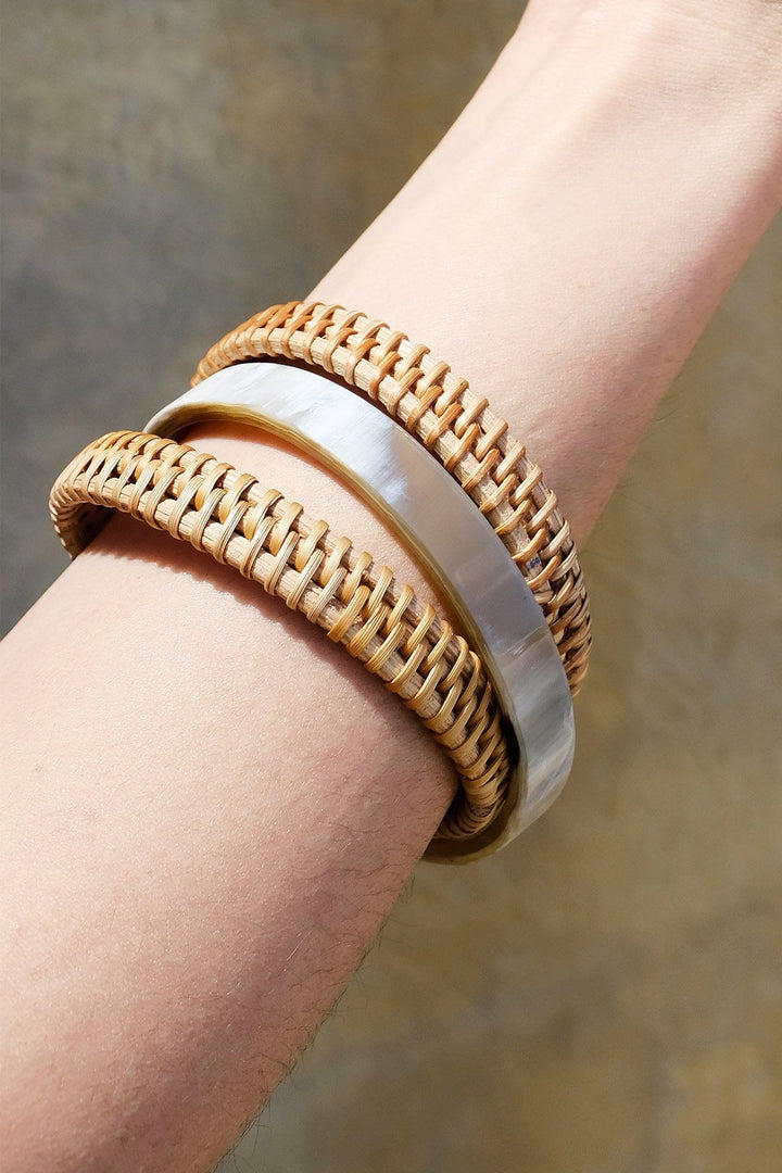 Set of buffalo horn and rattan bangles with natural textures.