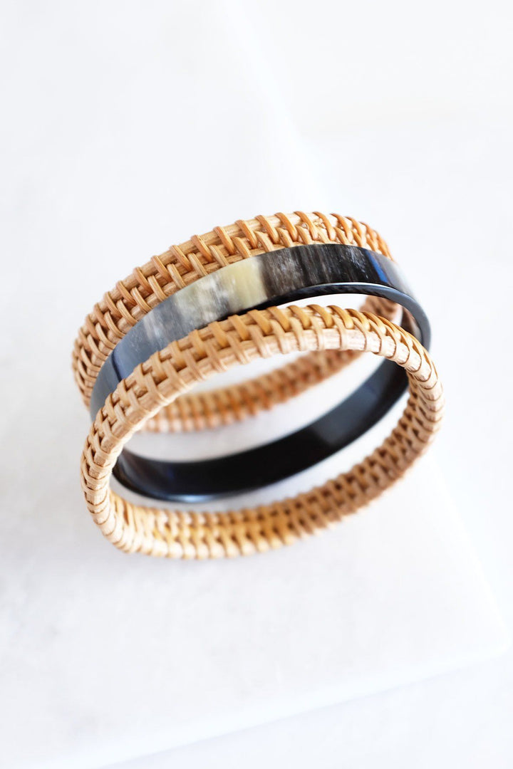 Set of buffalo horn and rattan bangles in earthy tones.
