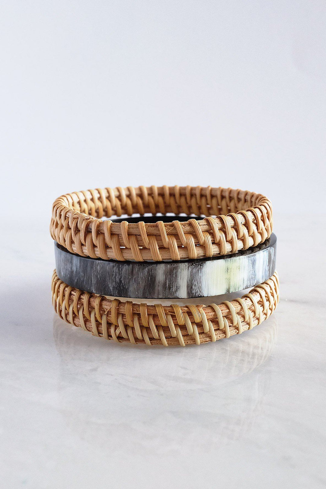 Set of dark-toned buffalo horn and rattan bangles.