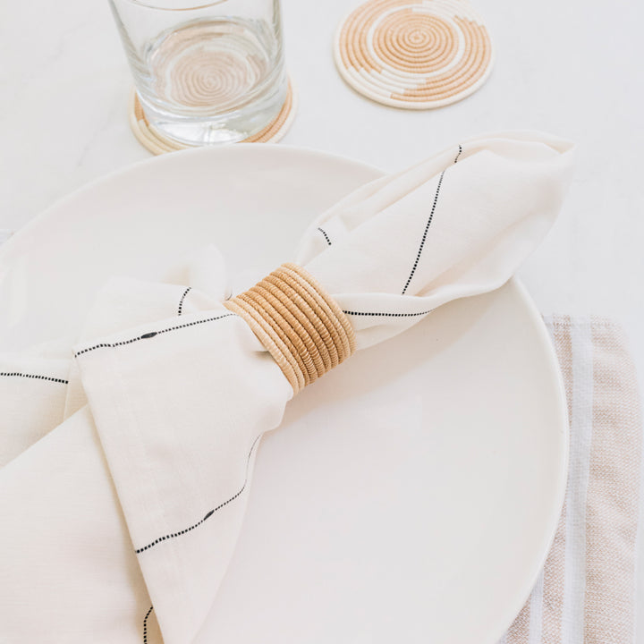 Handwoven sisal napkin rings in tea and natural white tones.