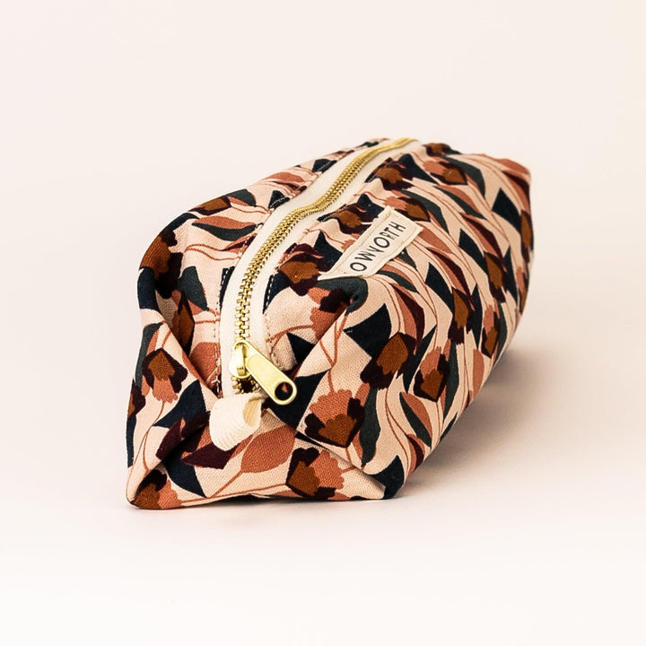 Florence pouch with floral fabric and zipper closure on neutral background.