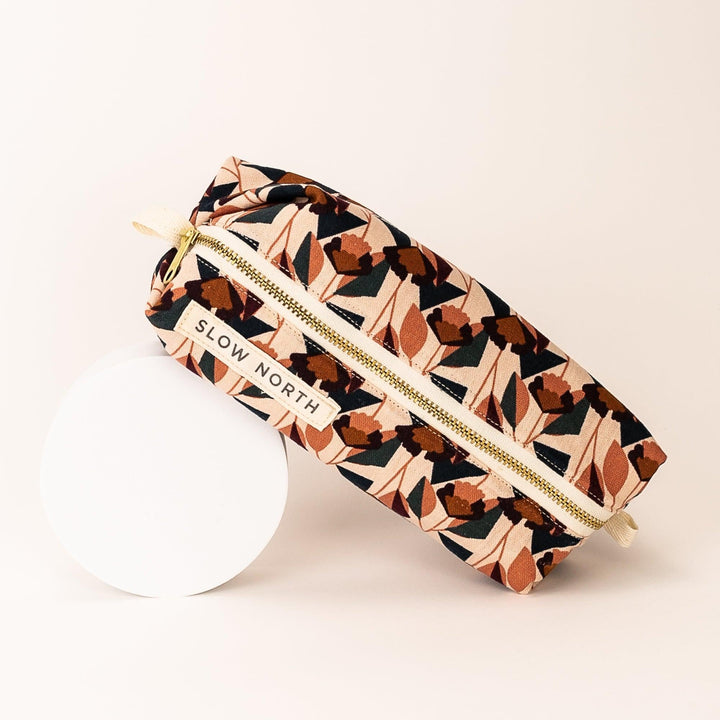 Florence travel pouch shown with detailed floral pattern and structured fabric.