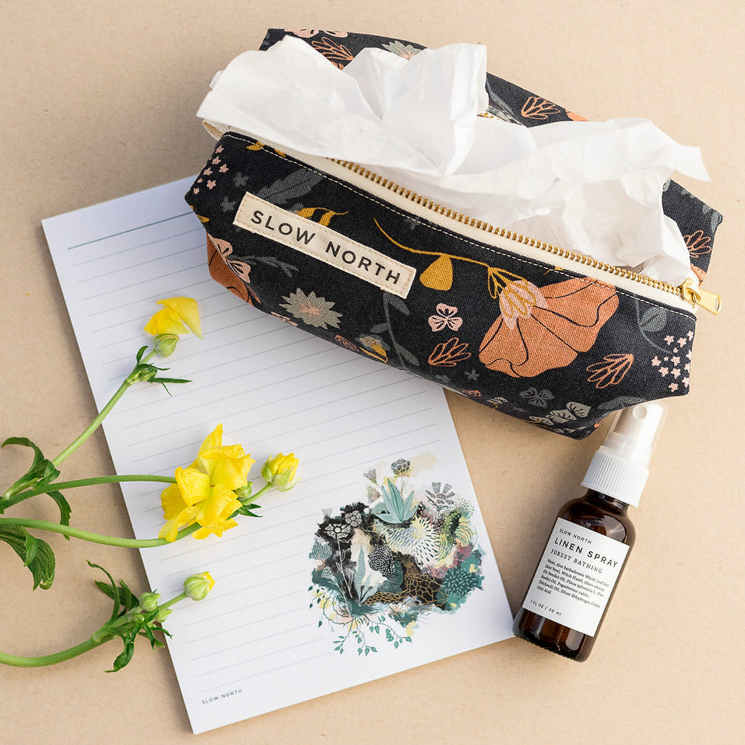 Compact pouch with textured cotton-linen exterior and structured shape.