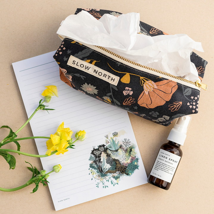 Compact pouch with textured cotton-linen exterior and structured shape.