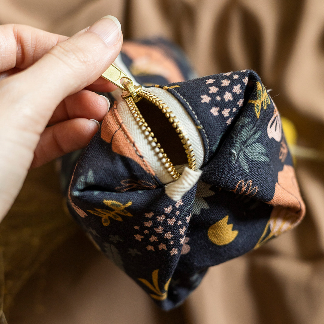 Canyon Springs pouch with zipper closure and rustic, neutral fabric.