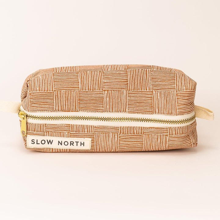 Copper Fields travel pouch with woven cotton-linen exterior and leather accent.