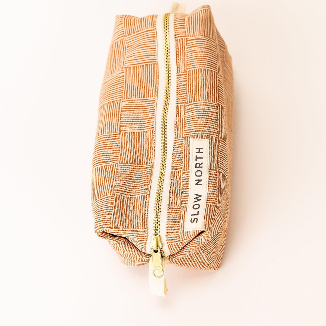 Cotton-linen pouch with leather detailing and brass zipper closure.