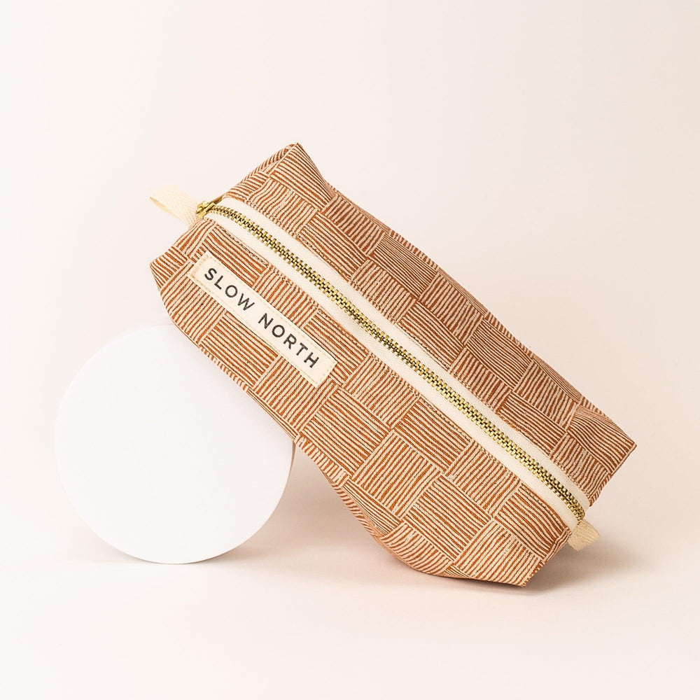 Copper Fields pouch with textured fabric and structured compact design.