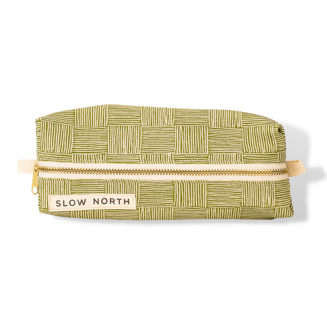 Greenhouse travel pouch in green cotton-linen exterior with compact, structured design.