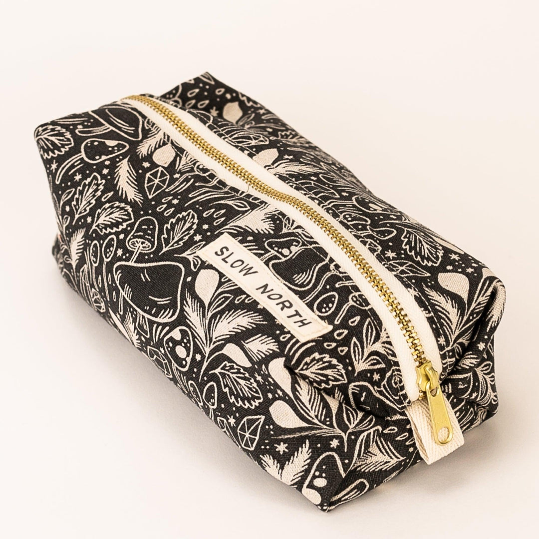 Mushroom illustration travel pouch with self-standing form and zipper.