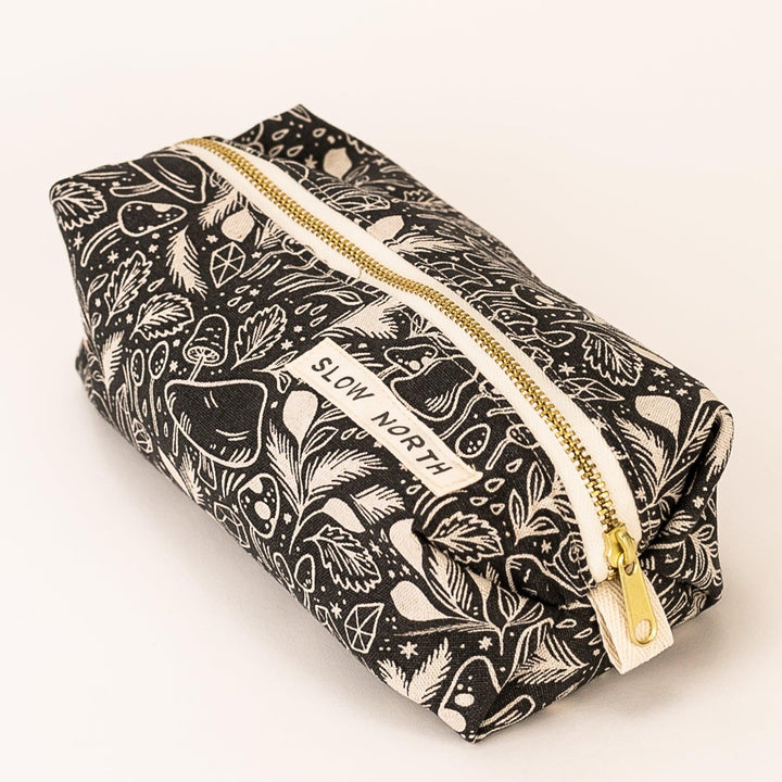 Mushroom illustration travel pouch with self-standing form and zipper.