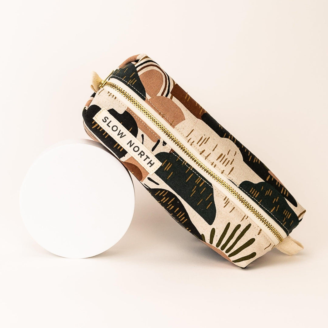 Compact Rainbow Hill pouch with colorful print and self-standing structure.