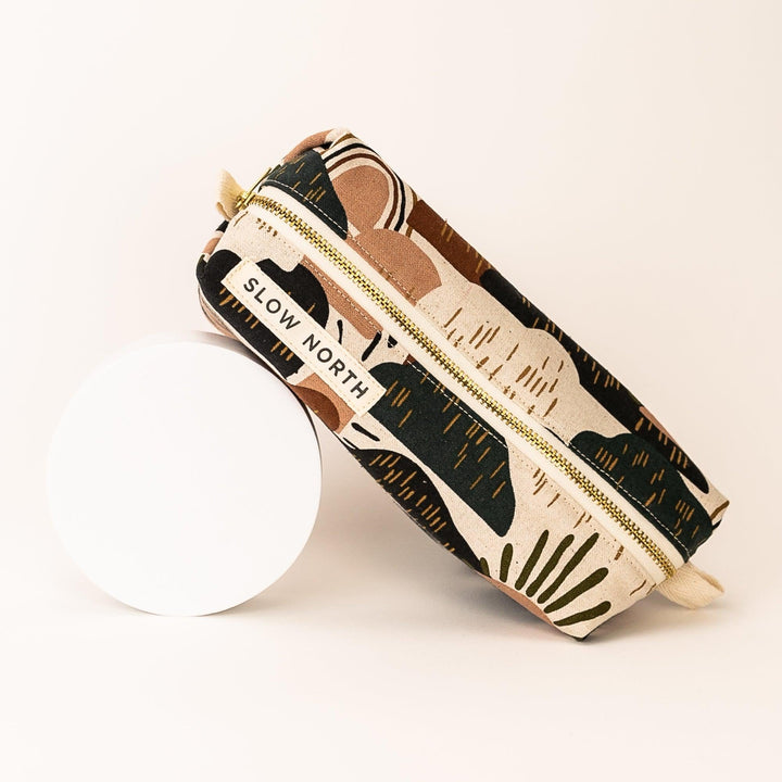 Compact Rainbow Hill pouch with colorful print and self-standing structure.