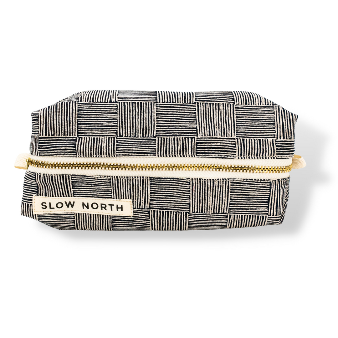 Haystack travel pouch with patterned cotton-linen exterior and leather accent detail.
