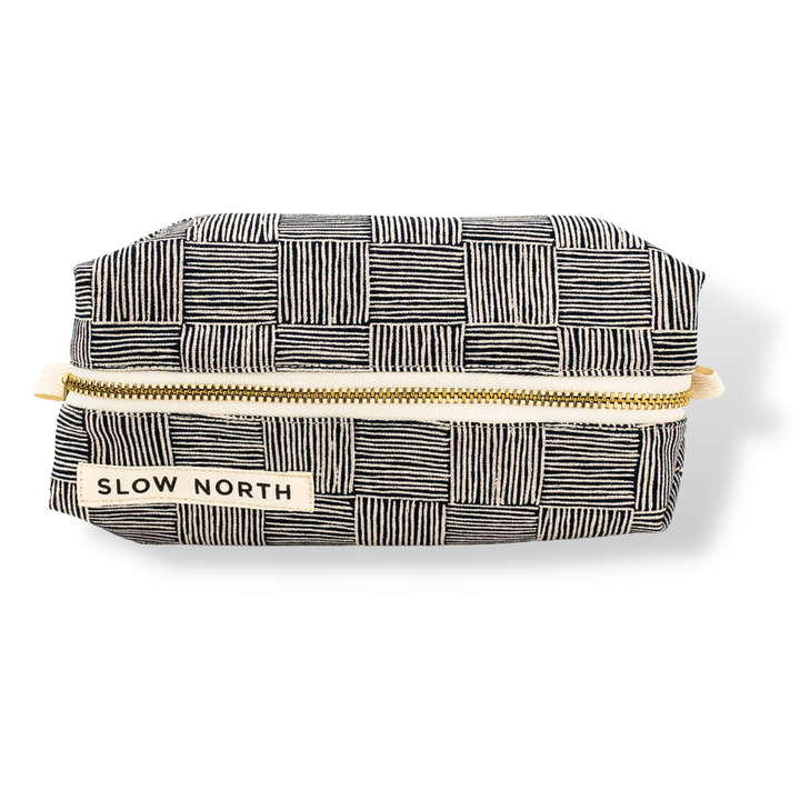 Haystack travel pouch with patterned cotton-linen exterior and leather accent detail.