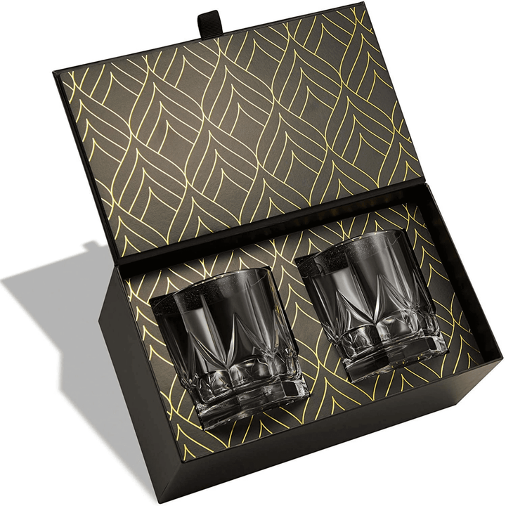 Set of handcrafted crystal whiskey tumblers, clear glass with an elegant design.