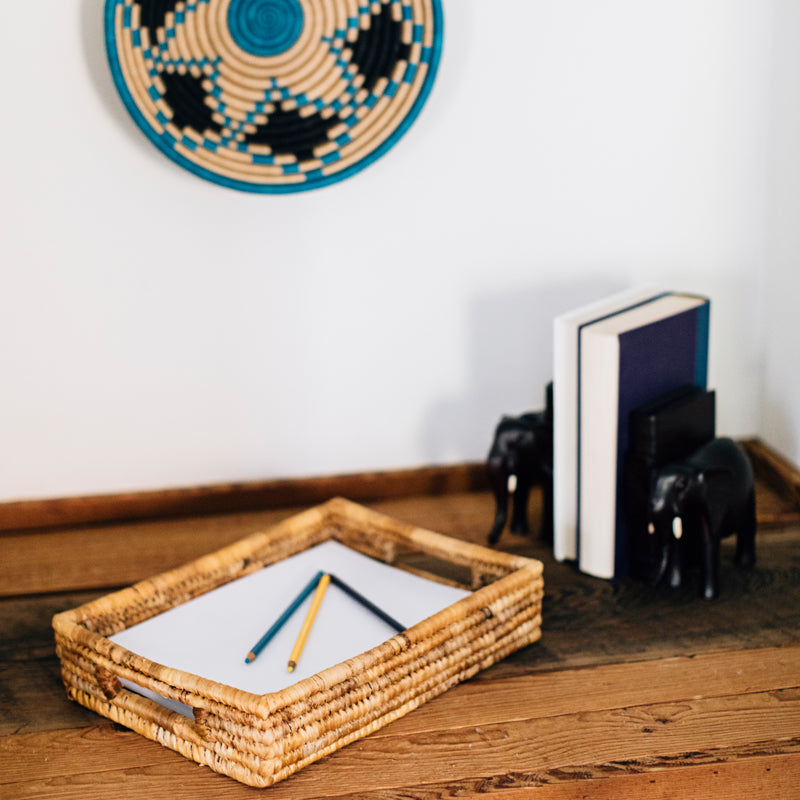 Natural woven banana leaf nesting trays displayed with small woven bowls.