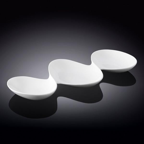 Porcelain divided sauce dish with three compartments, white with a sleek design.